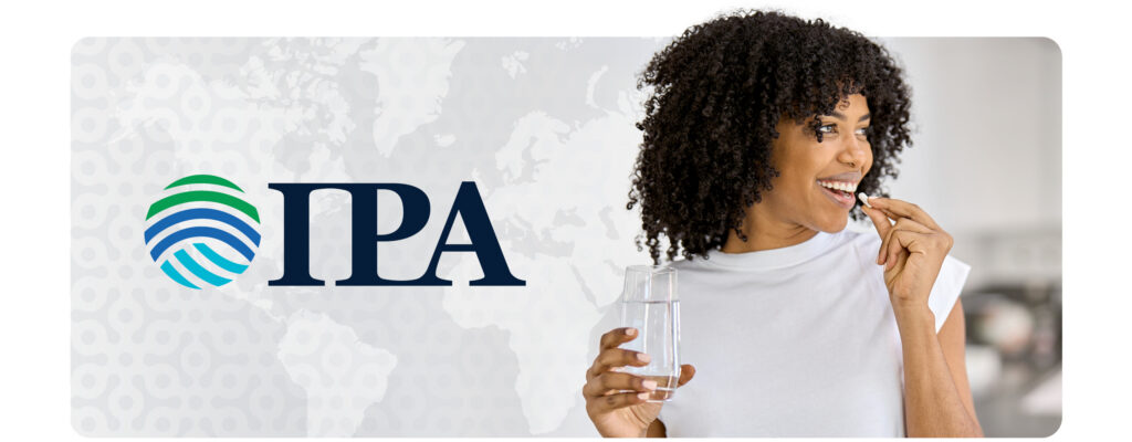 A woman putting a probiotic supplement in her mouth